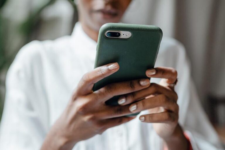 A black woman browsing the internet on an iPhone