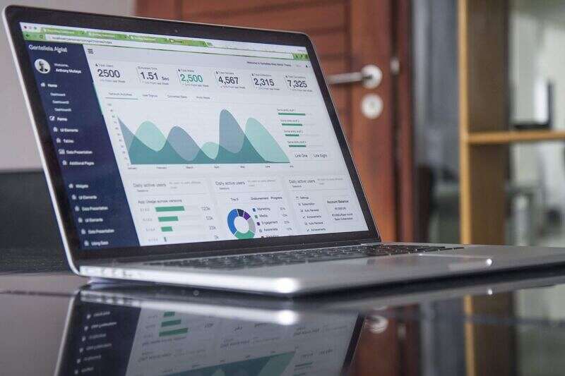 Laptop showing income in graphs