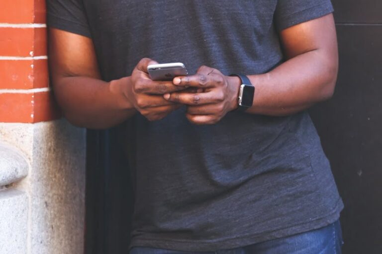 Man using an iPhone while standing