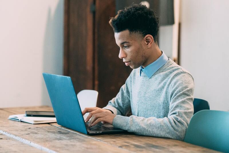 Man typing on a laptop