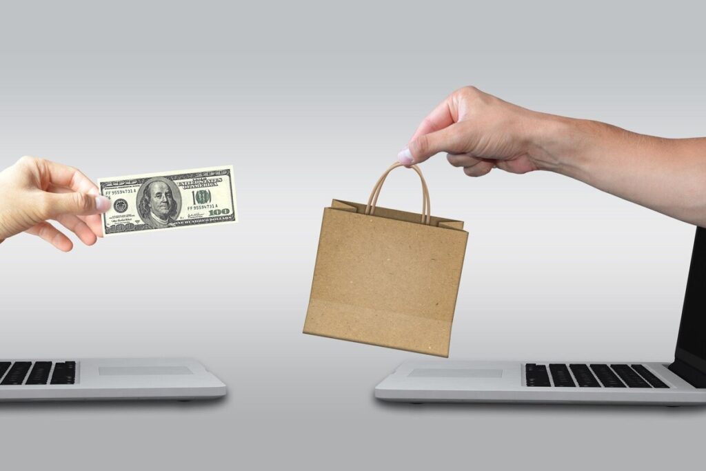 hand exchanging money and goods