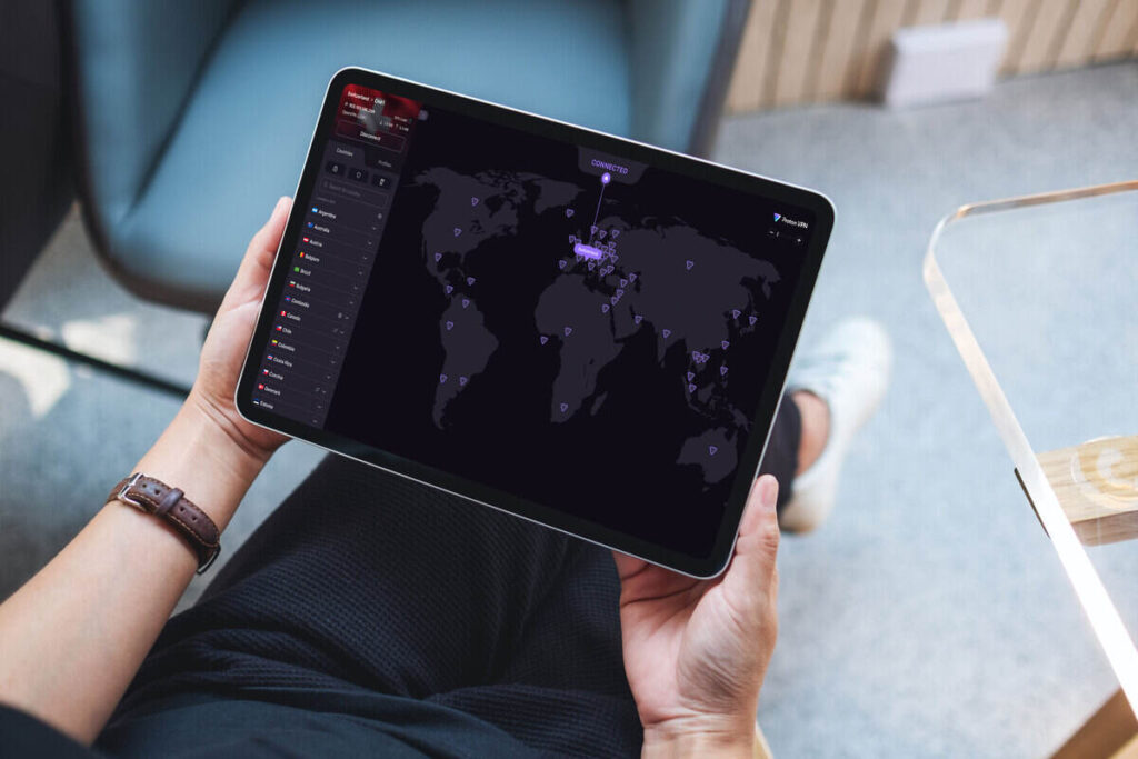 person holding tablet with proton vpn on screen