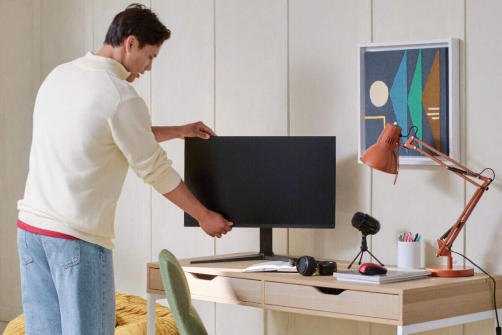 Man with a few amazon basic gadgets on a desk