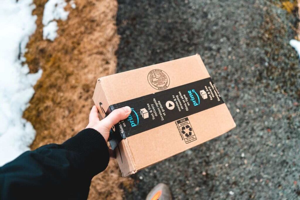 Man holding amazon prime delivery box