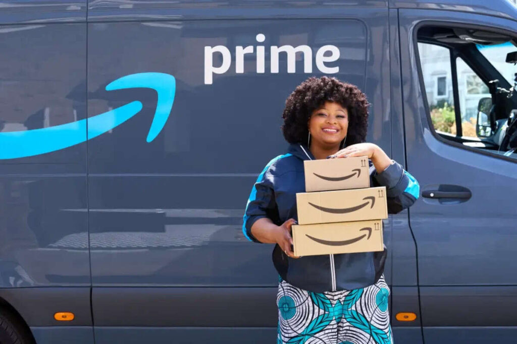 woman carrying three amazon prime delivery boxes