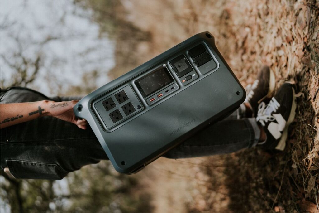 Man carrying a portable power station outdoors